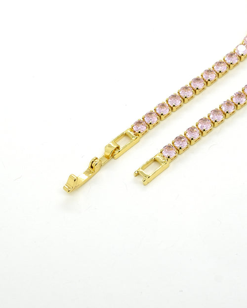 A timeless gold-plated tennis bracelet featuring elegant rose-pink stones that add a soft sparkle and luxurious charm to any look